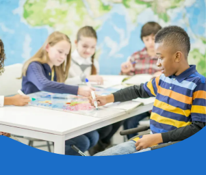 Children studying together at a table with a globe in a classroom.